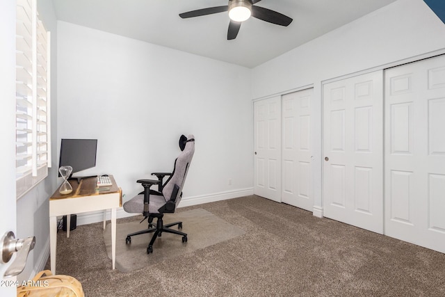 unfurnished office featuring carpet floors, baseboards, and a ceiling fan