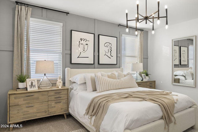 carpeted bedroom with a chandelier