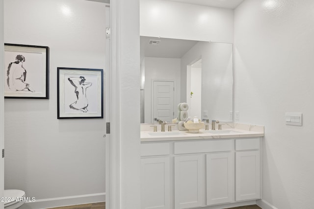 bathroom with vanity and toilet