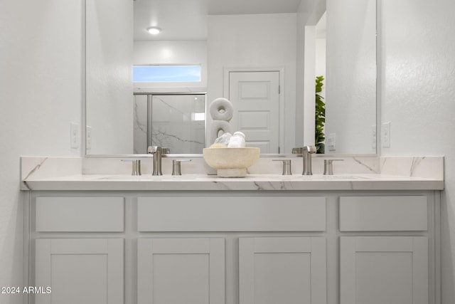 bathroom featuring vanity and a shower with shower door