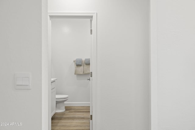 bathroom featuring vanity, toilet, and wood-type flooring