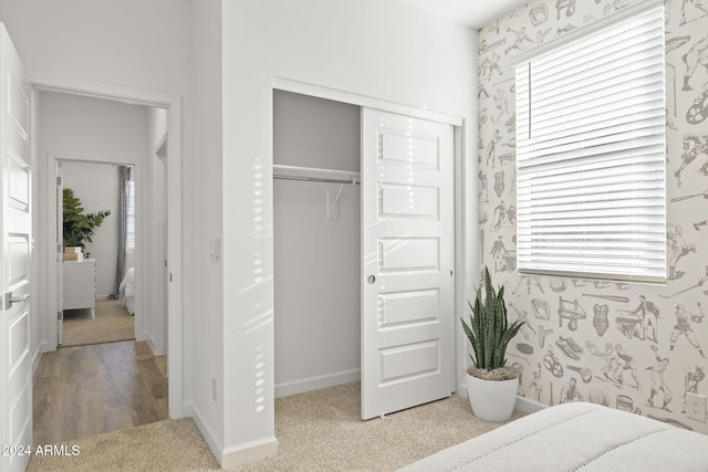 bedroom with a closet and hardwood / wood-style flooring