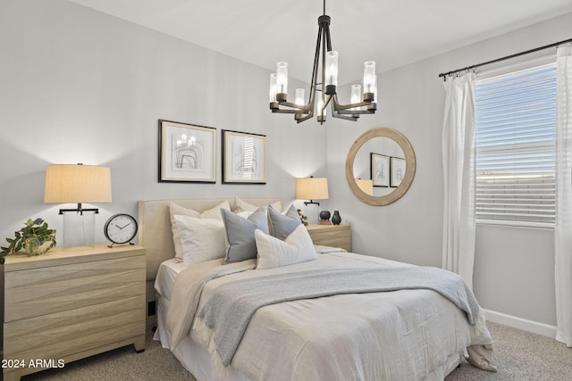 bedroom featuring light colored carpet and an inviting chandelier