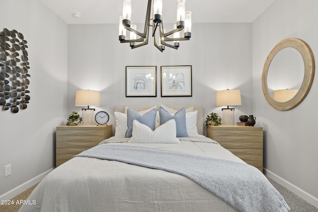 carpeted bedroom featuring an inviting chandelier