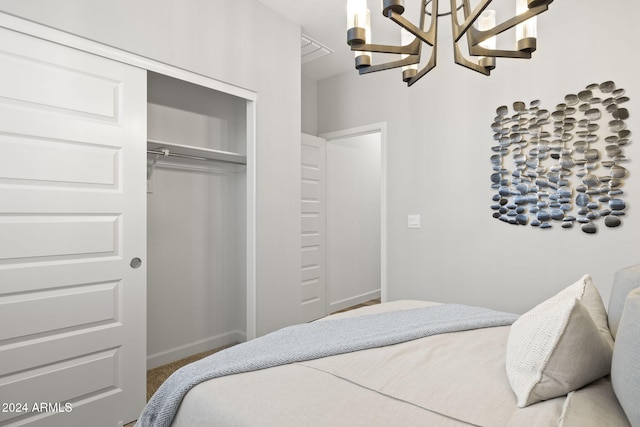 bedroom featuring carpet flooring, a closet, and a chandelier