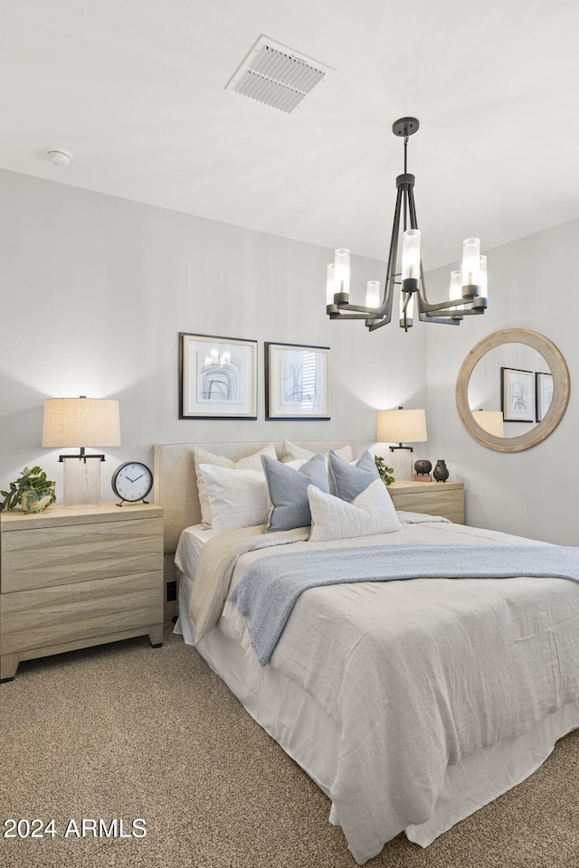 carpeted bedroom with a chandelier