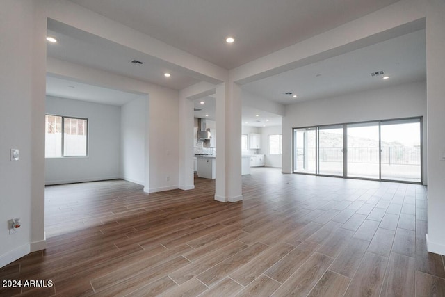 unfurnished living room featuring light hardwood / wood-style floors