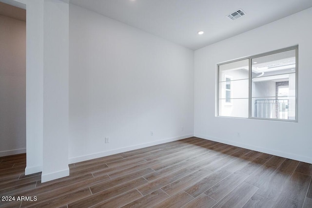 unfurnished room with dark hardwood / wood-style floors