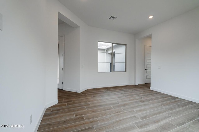 spare room with light hardwood / wood-style flooring