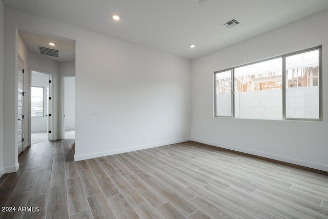 spare room featuring light wood-type flooring