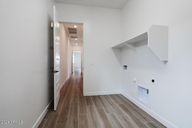 laundry room with hookup for a washing machine, hardwood / wood-style floors, gas dryer hookup, and electric dryer hookup