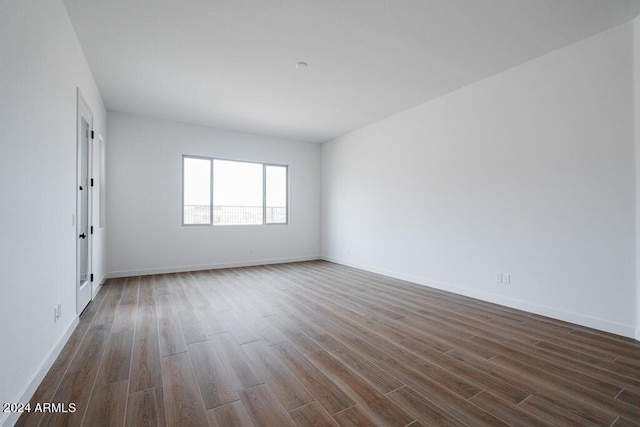 spare room featuring wood-type flooring