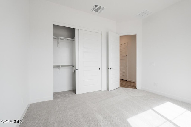 unfurnished bedroom featuring a closet and carpet floors