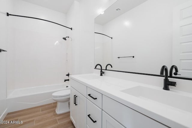 full bathroom featuring toilet,  shower combination, and vanity