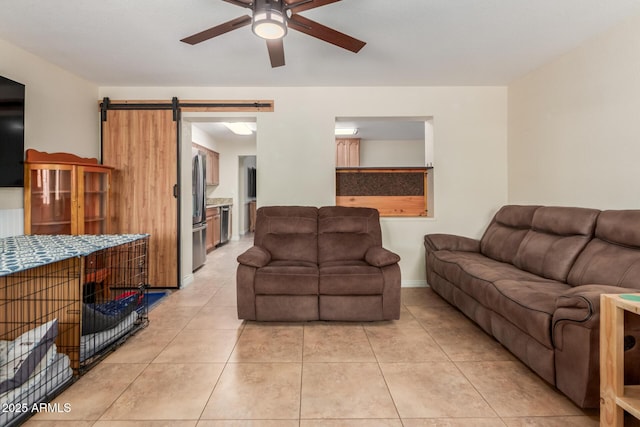 538 E Estevan Ave, Apache Junction, AZ 85119 - living room with a barn door, a ceiling fan, and light tile patterned floors