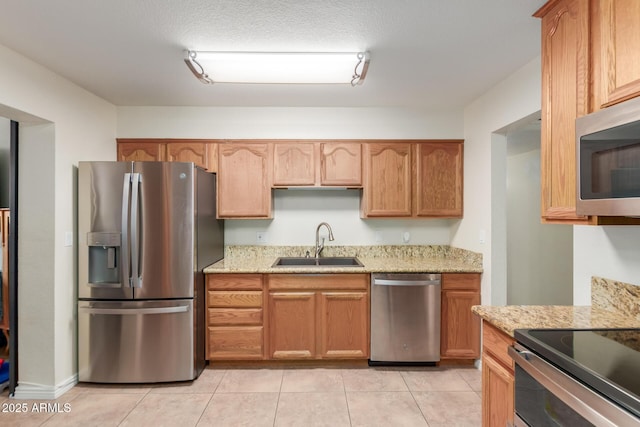 538 E Estevan Ave, Apache Junction, AZ 85119 - kitchen with stainless steel appliances, light stone counters, and light tile patterned flooring