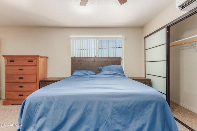 538 E Estevan Ave, Apache Junction, AZ 85119 - bedroom with carpet floors, a wall unit AC, a closet, and a ceiling fan