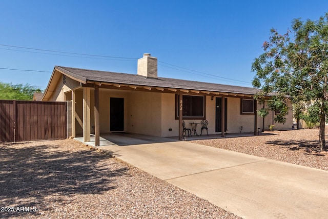 538 E Estevan Ave, Apache Junction, AZ 85119 - single story home featuring concrete driveway, a chimney, a carport, stucco siding, and a porch