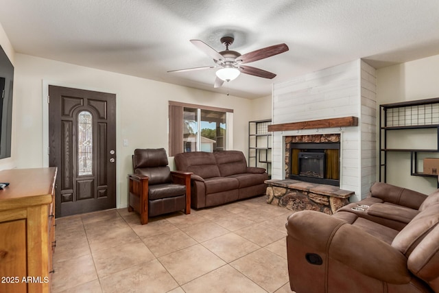 538 E Estevan Ave, Apache Junction, AZ 85119 - living area featuring ceiling fan, a fireplace, light tile patterned floors, and a textured ceiling