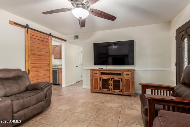 538 E Estevan Ave, Apache Junction, AZ 85119 - living area featuring a barn door, ceiling fan, and light tile patterned flooring