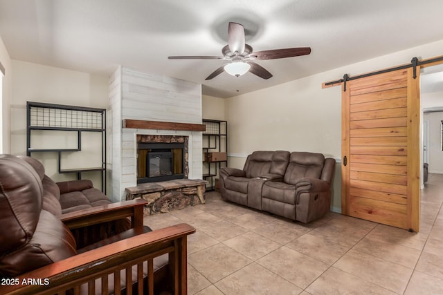 538 E Estevan Ave, Apache Junction, AZ 85119 - living room with a barn door, a ceiling fan, light tile patterned floors, and a fireplace