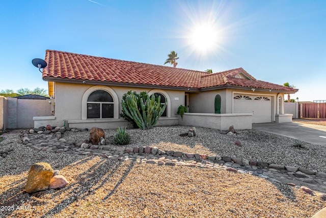 9169 W Ludlow Dr W, Peoria, AZ 85381 - mediterranean / spanish house featuring driveway, a tile roof, fence, and stucco siding