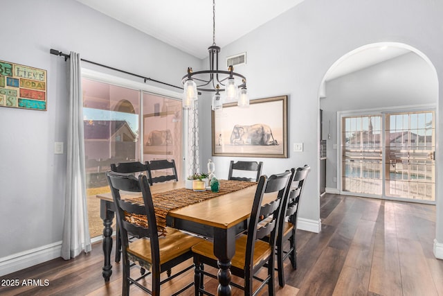 9169 W Ludlow Dr W, Peoria, AZ 85381 - dining area with a notable chandelier, dark wood-style floors, baseboards, visible vents, and arched walkways