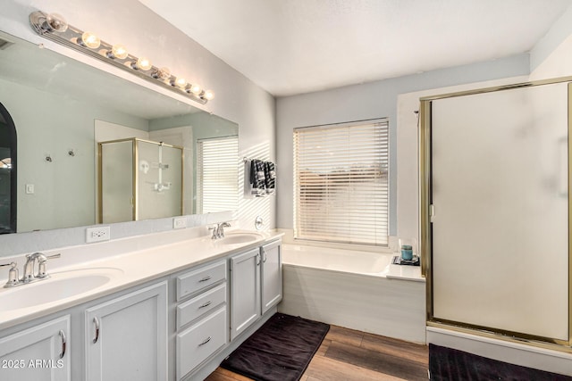 9169 W Ludlow Dr W, Peoria, AZ 85381 - bathroom featuring a sink, a shower stall, wood finished floors, a bath, and double vanity