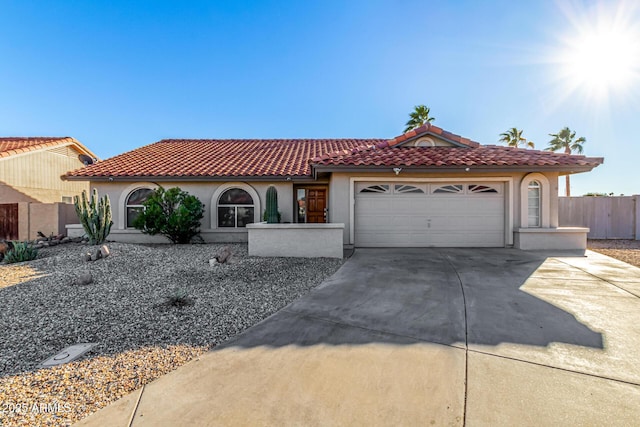 9169 W Ludlow Dr W, Peoria, AZ 85381 - mediterranean / spanish house featuring fence, a garage, concrete driveway, a tile roof, and stucco siding