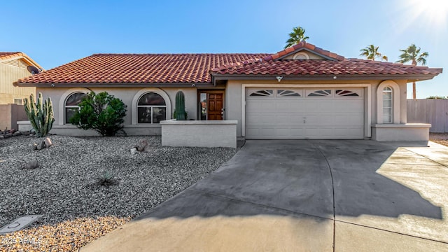 9169 W Ludlow Dr W, Peoria, AZ 85381 - mediterranean / spanish-style house featuring driveway, stucco siding, an attached garage, and a tiled roof