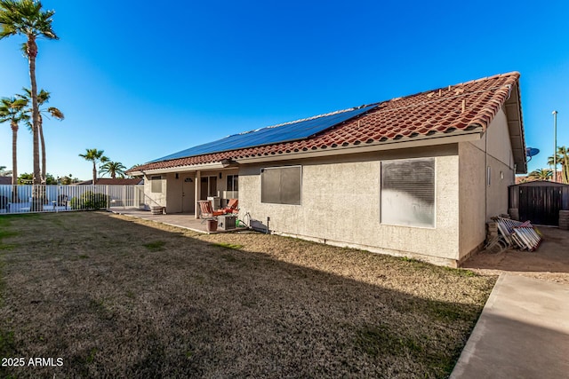 9169 W Ludlow Dr W, Peoria, AZ 85381 - rear view of property featuring stucco siding, a fenced backyard, solar panels, a patio, and a lawn