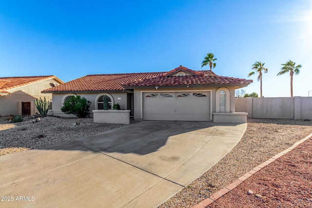 9169 W Ludlow Dr W, Peoria, AZ 85381 - mediterranean / spanish house with stucco siding, fence, a tiled roof, driveway, and a garage