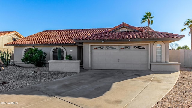 9169 W Ludlow Dr W, Peoria, AZ 85381 - mediterranean / spanish home featuring concrete driveway, stucco siding, fence, an attached garage, and a tiled roof