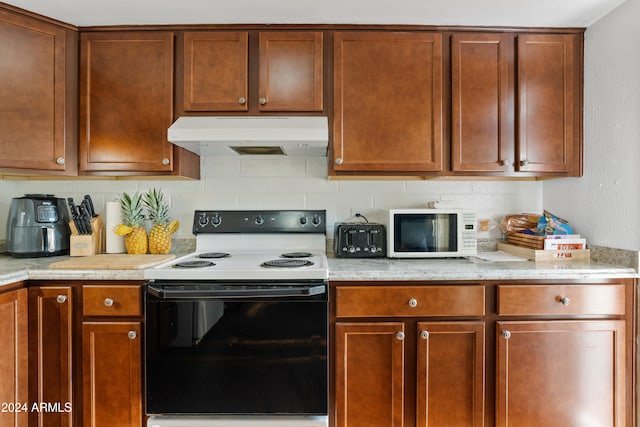 kitchen with white appliances and backsplash