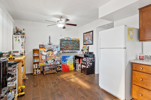 kitchen with a textured ceiling, dark hardwood / wood-style floors, ceiling fan, and white fridge