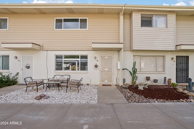 view of property featuring an outdoor living space and a patio