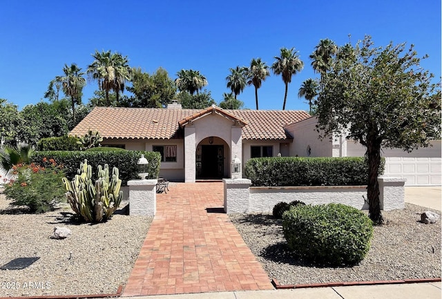 8666 E Cheryl Dr, Scottsdale, AZ 85258 - mediterranean / spanish house featuring stucco siding, a tiled roof, and a chimney