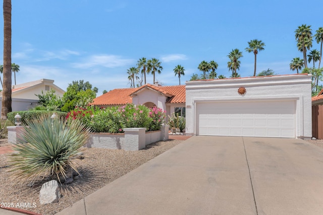 8666 E Cheryl Dr, Scottsdale, AZ 85258 - mediterranean / spanish-style home featuring a tiled roof, an attached garage, driveway, and stucco siding