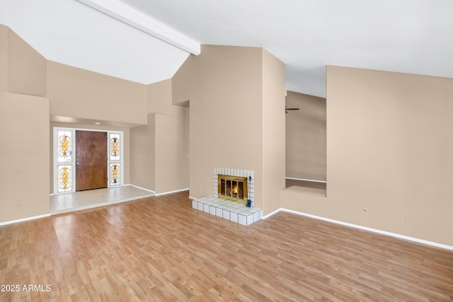 8666 E Cheryl Dr, Scottsdale, AZ 85258 - unfurnished living room with a fireplace, beam ceiling, wood finished floors, baseboards, and high vaulted ceiling