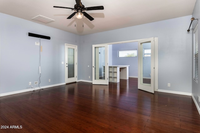 empty room with dark hardwood / wood-style flooring, ceiling fan, and french doors