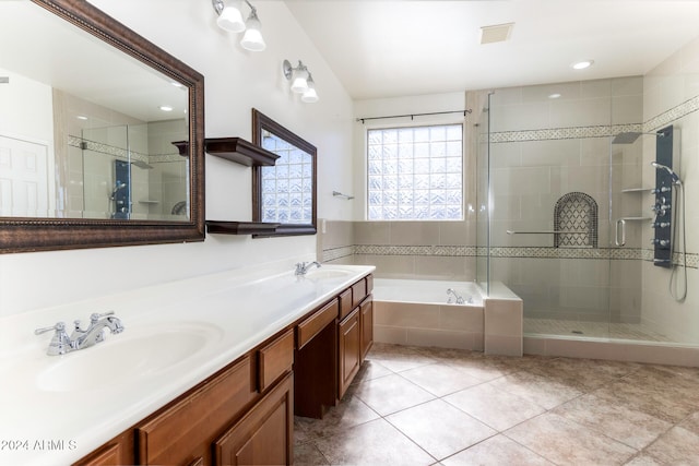 bathroom with tile patterned flooring, vanity, and shower with separate bathtub