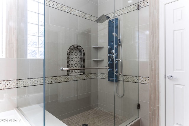 bathroom with a shower with shower door