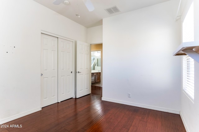 unfurnished bedroom featuring dark hardwood / wood-style flooring, a closet, and ceiling fan