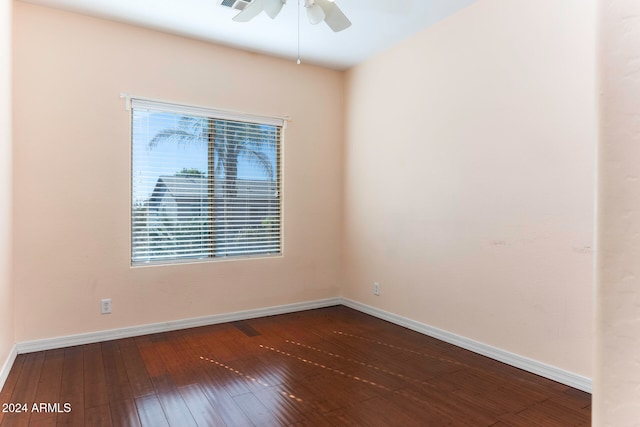 spare room with ceiling fan and dark hardwood / wood-style floors