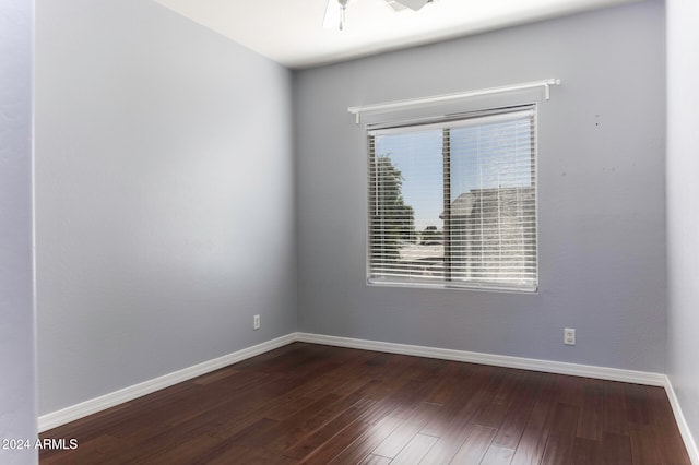 unfurnished room with ceiling fan and dark hardwood / wood-style floors