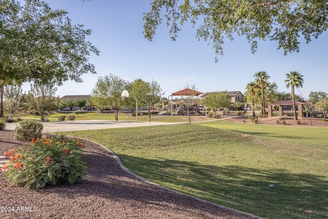 surrounding community with a lawn and basketball court