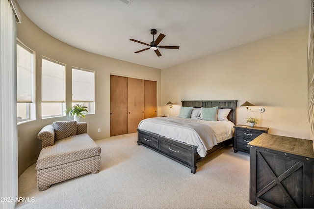 bedroom with carpet floors, a closet, and a ceiling fan