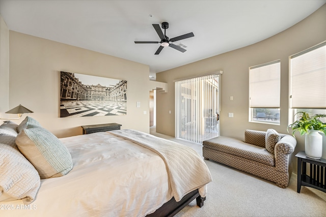 carpeted bedroom featuring access to exterior and a ceiling fan