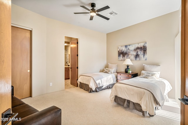 bedroom with visible vents, ensuite bath, ceiling fan, carpet, and a closet