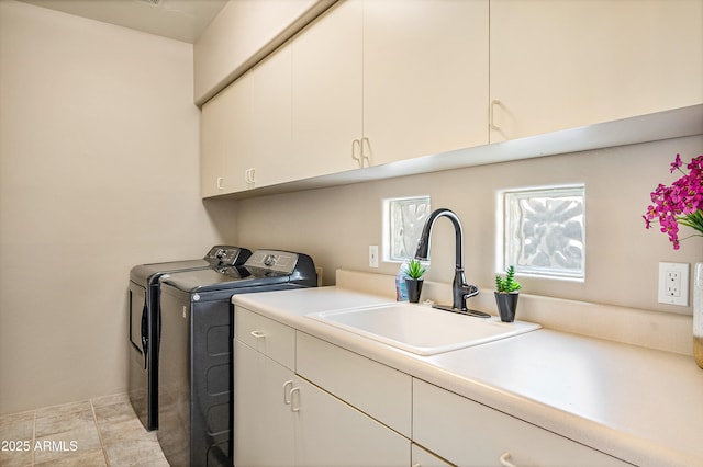 laundry room featuring independent washer and dryer, cabinet space, and a sink